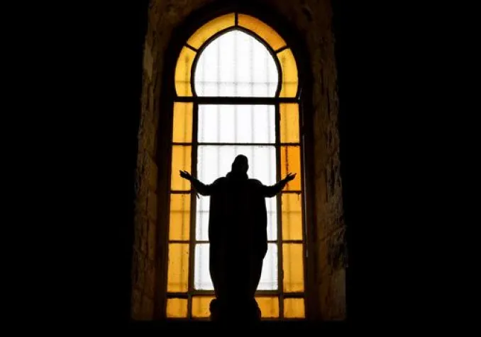 Une figure de Jésus-Christ se profile sur une fenêtre de l'église de Deir Al Qamar au Liban. KEYSTONE - WAEL HAMZEH